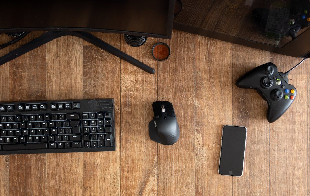 A desktop setup includes monitor, mouse, phone and keyboard